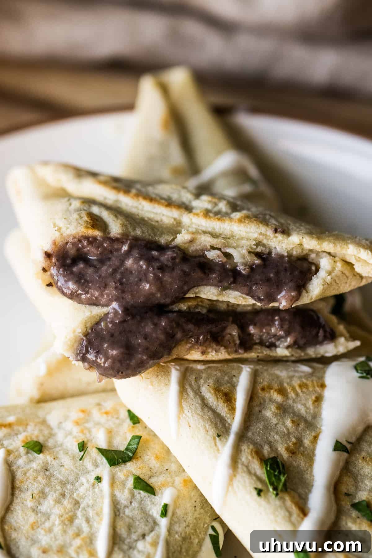 Mexican Masa Pockets 15 A tetela cut in half to show the black bean and cheese filling.