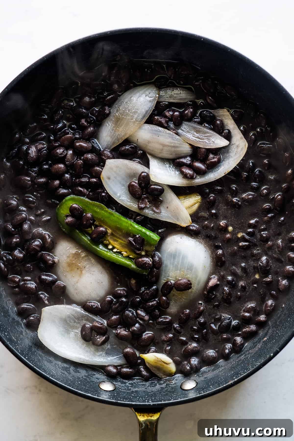 Mexican Masa Pockets 5 Black beans, onion, jalapeño, and garlic cooking in a skillet.