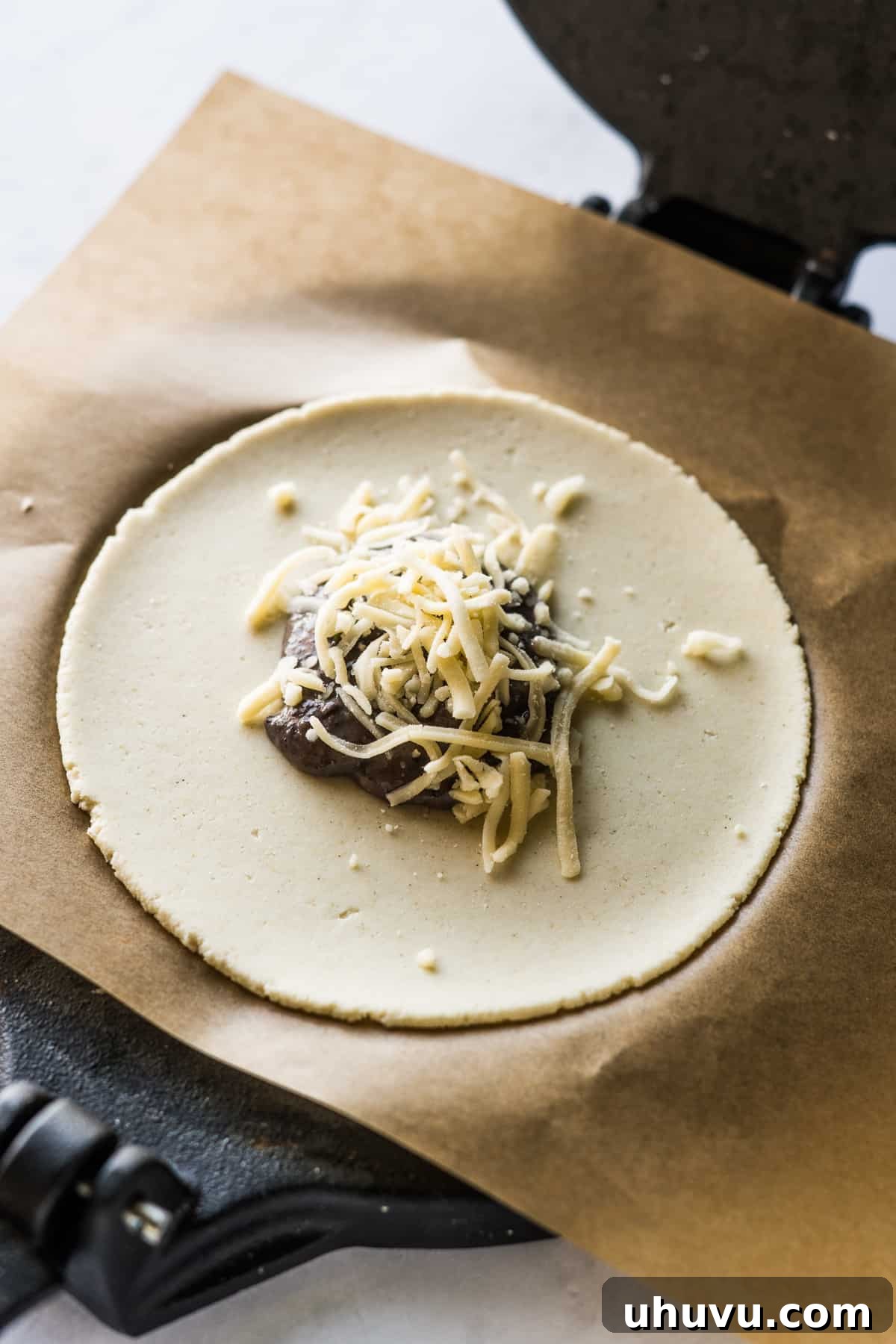 Mexican Masa Pockets 9 Pressed masa harina on a tortilla press topped with black beans and cheese.