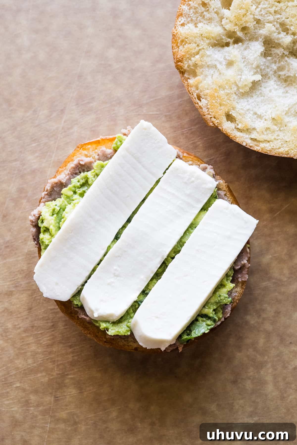 Authentic Mexican Torta 11 Layers of queso fresco, refried beans, and guacamole on a telera roll.