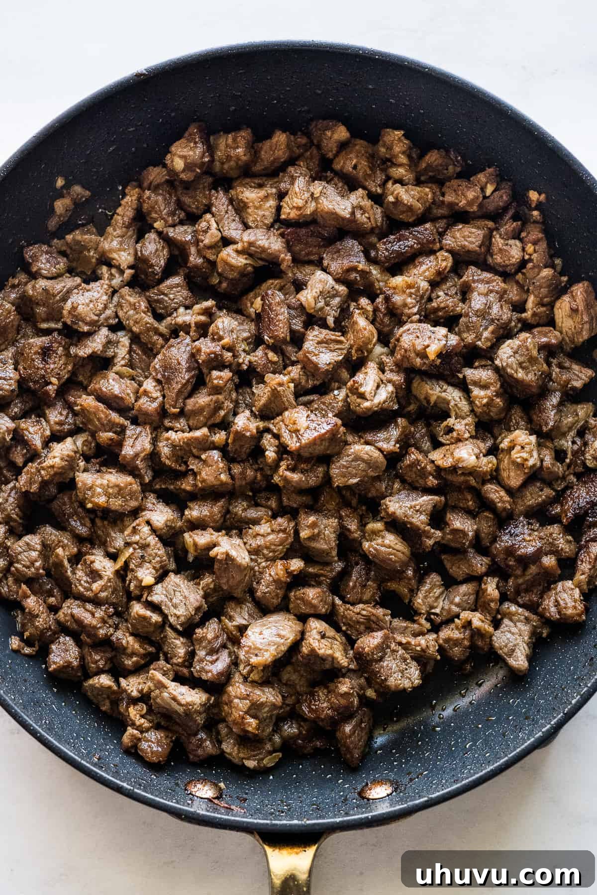 Authentic Mexican Torta 5 Perfectly cooked chuck steak in a skillet, ready to be a delicious filling in Mexican tortas.