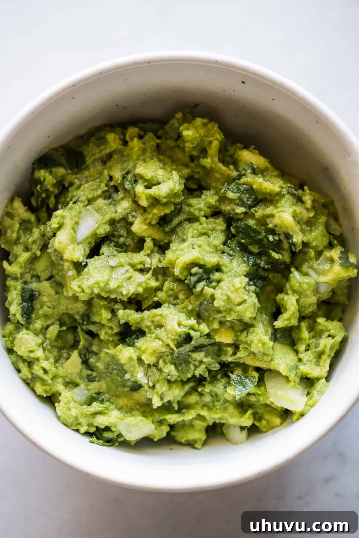Authentic Mexican Torta 6 Freshly made guacamole in a bowl, awaiting its role as a key filling in tortas.