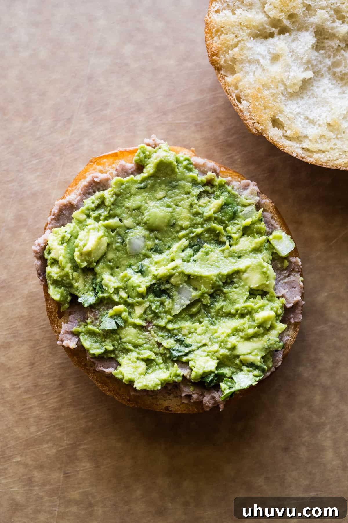 Authentic Mexican Torta 10 Refried beans and creamy guacamole spread on a telera roll.