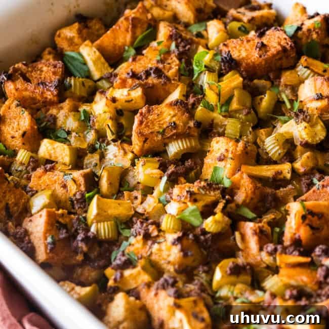 Spicy Chorizo Stuffing 11 A baking dish of chorizo stuffing garnished with fresh parsley and made with apples, onion, and celery.