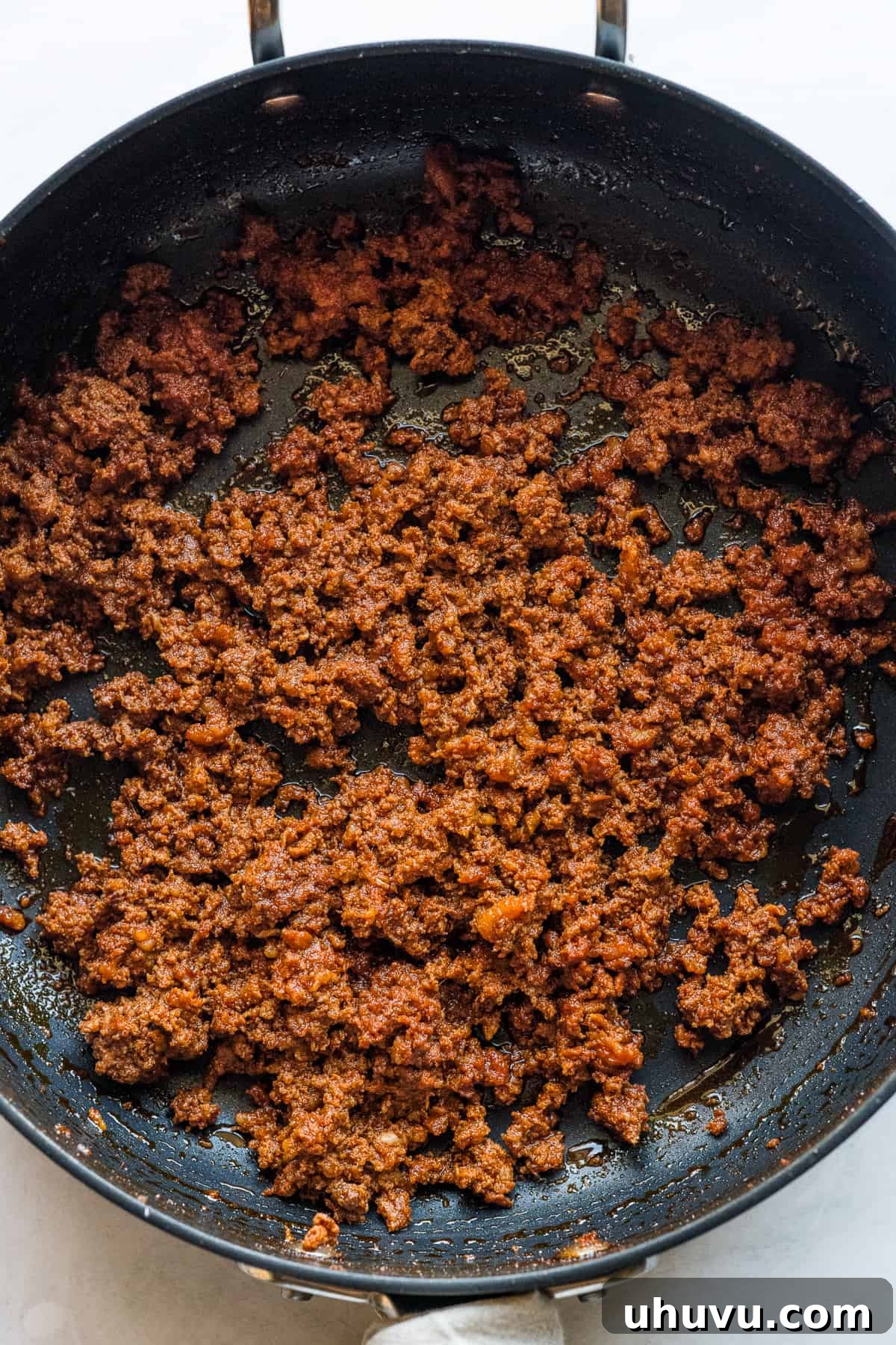 Spicy Chorizo Stuffing 5 A skillet filled with beautifully browned and crumbled Mexican chorizo, with its vibrant red oils rendered, ready to be removed.