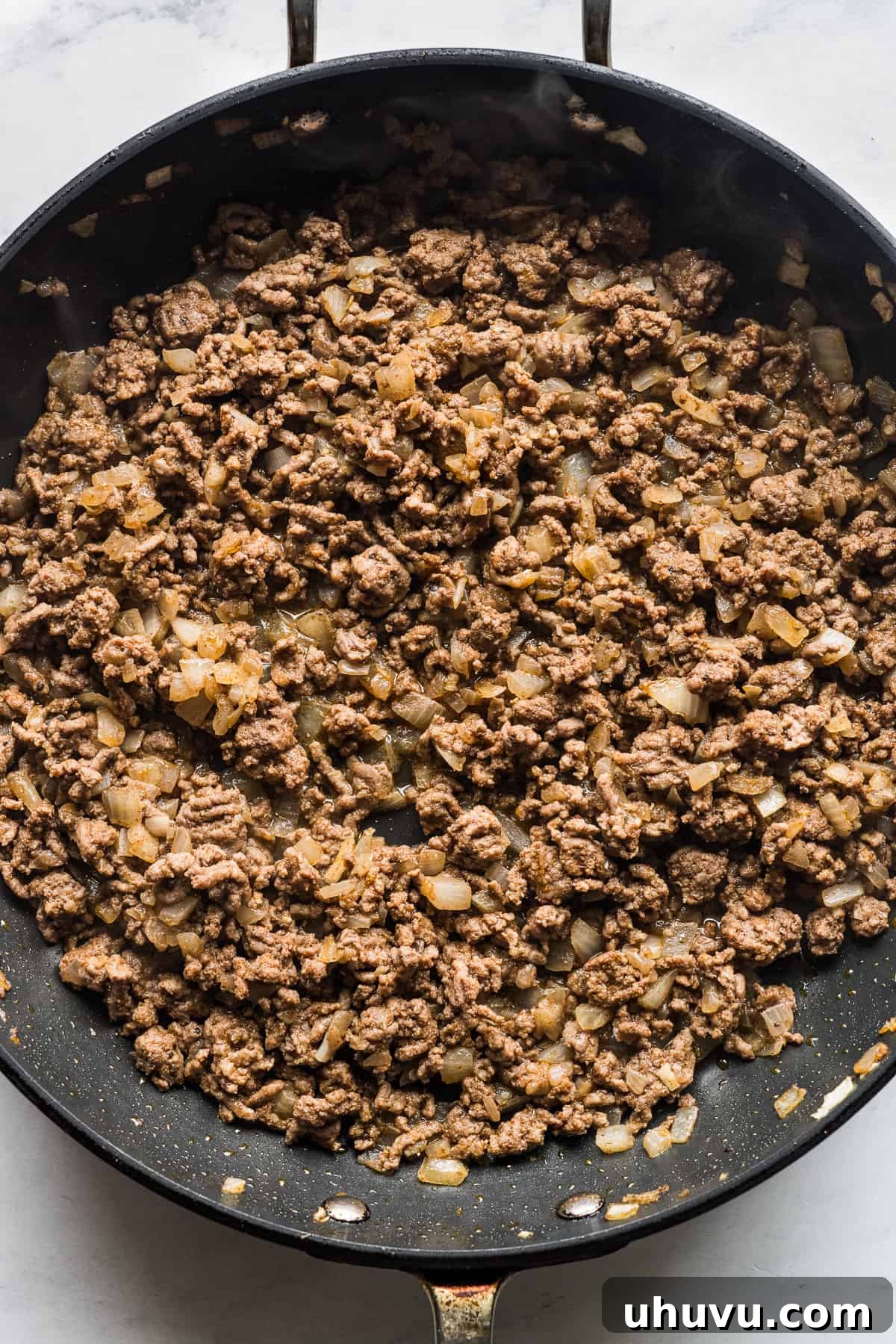 Golden Crispy Tacos 4 Cooked ground beef in a skillet.
