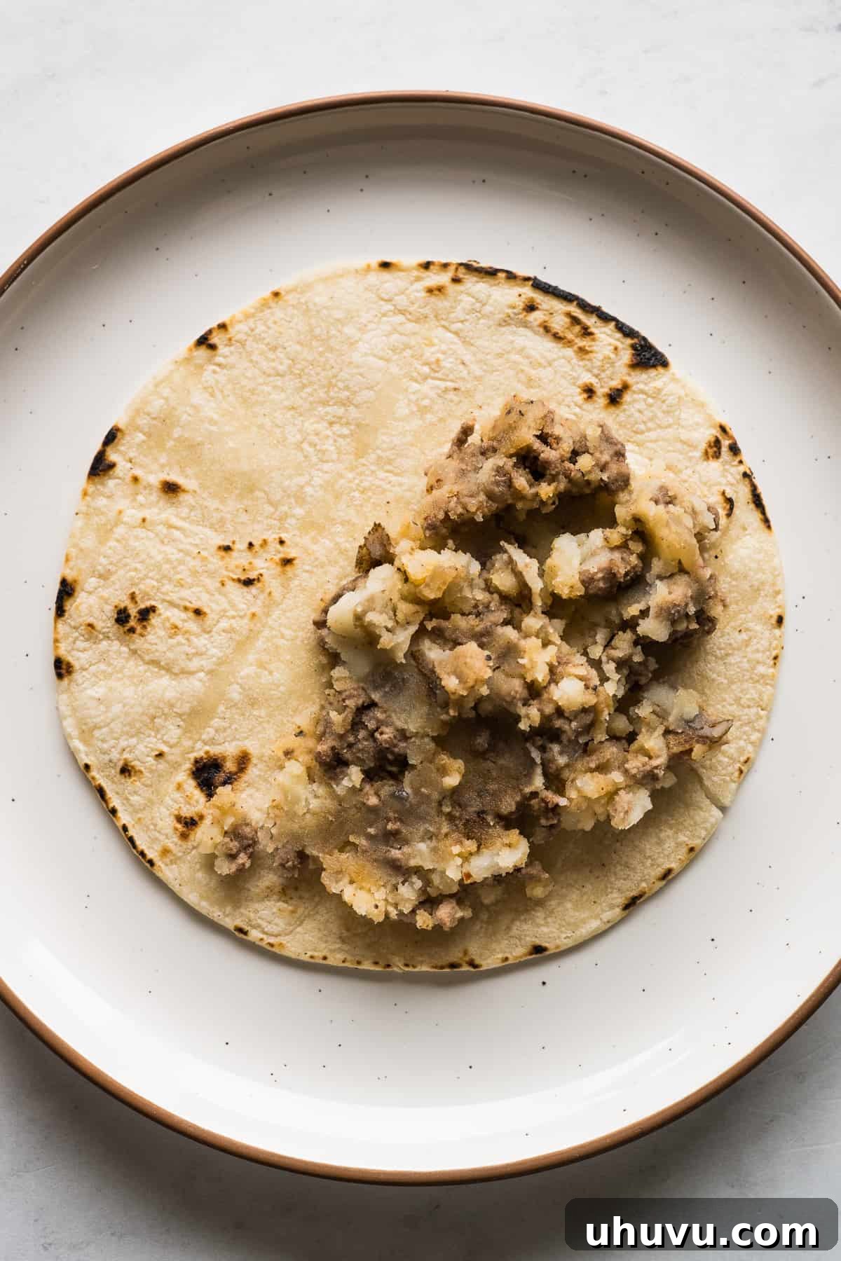 Golden Crispy Tacos 6 A corn tortilla with a filling of mashed potatoes and ground beef.