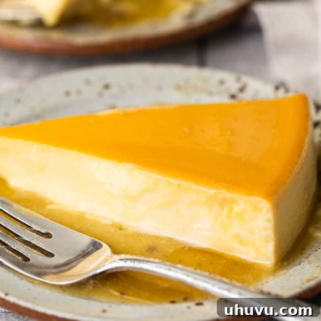 Rich Cheese Flan 10 Flan de Queso with caramel sauce elegantly presented on a white plate, ready to be served.