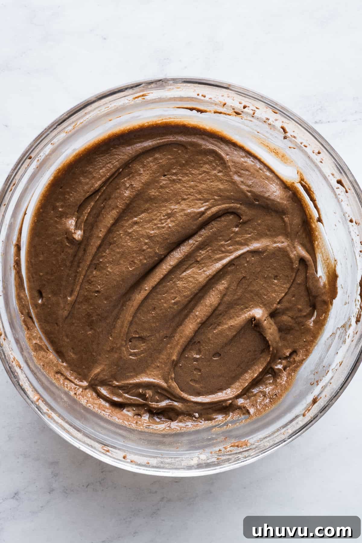 Chocolate Flan Fusion 7 The fully mixed, smooth, and rich chocolate cake batter for chocoflan in a large mixing bowl, ready for layering.