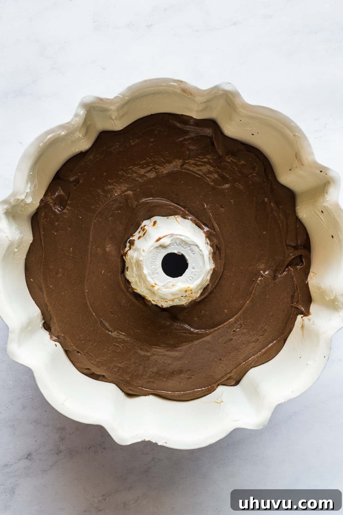 Chocolate Flan Fusion 9 The dense chocolate cake batter evenly spread in the bundt pan, forming the first layer of the chocoflan.