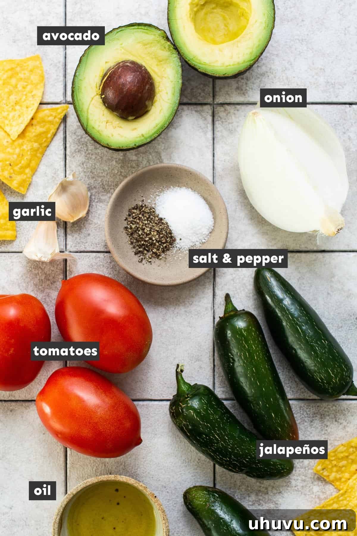Vibrant Mexican Salsa 3 All the fresh ingredients for homemade Salsa Mexicana laid out on a rustic wooden table, including jalapeños, Roma tomatoes, onion, garlic, and an avocado.