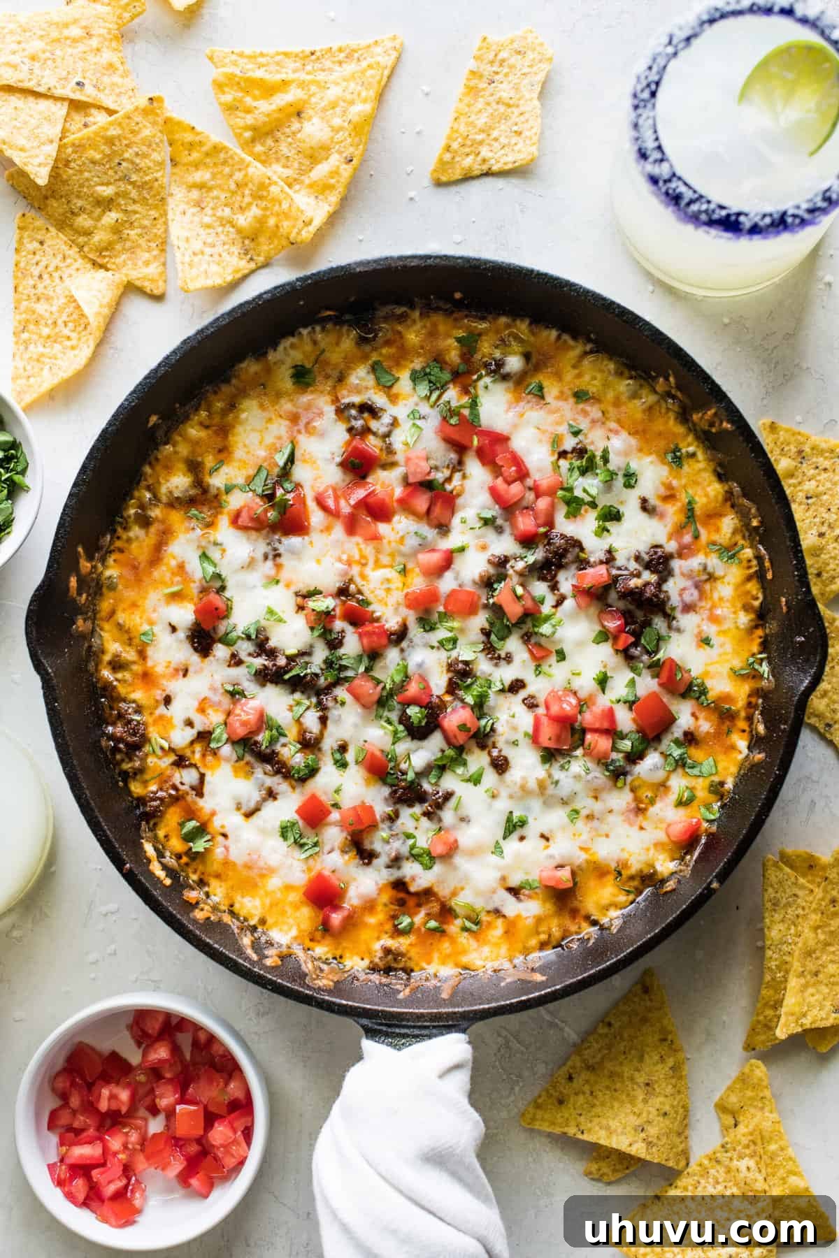 Top 20 Irresistible Mexican Bites for Your Epic Fiesta 3 Queso Fundido, a skillet of bubbling melted cheese and chorizo, ready for dipping.