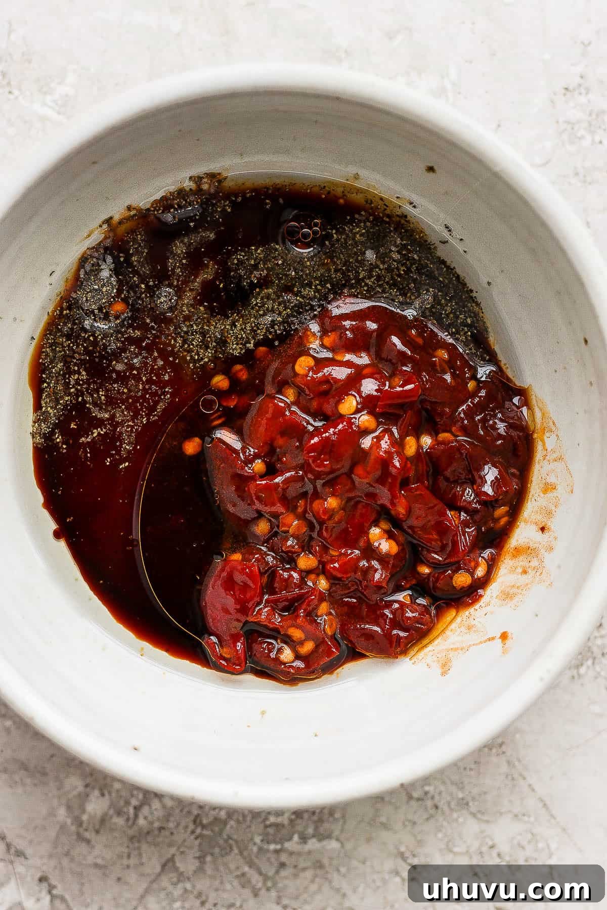 Air-Fried Salmon Nuggets 4 Honey, chopped chipotle peppers in adobo, and soy sauce being whisked together in a small bowl to form the marinade.