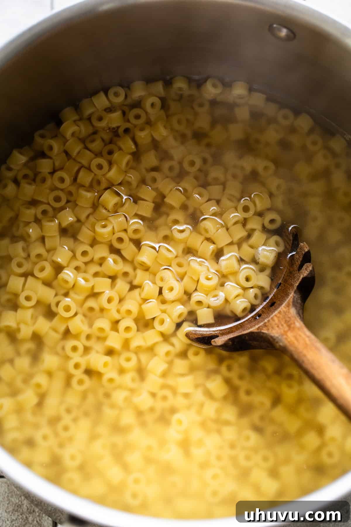 Freshly cooked ditalini pasta in a pot, drained and ready to be tossed with olive oil for the street corn pasta salad.