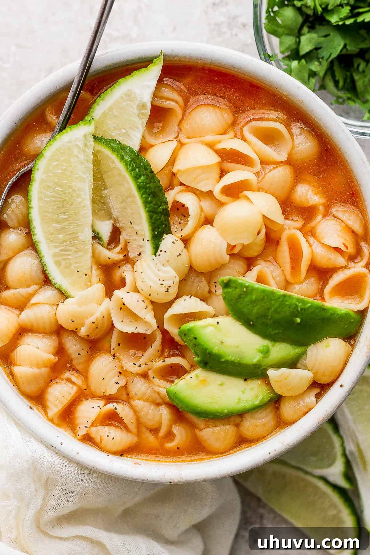 Little Shell Pasta Soup 2 A steaming bowl of Sopa de Conchas, topped with fresh avocado slices, ready to be enjoyed.