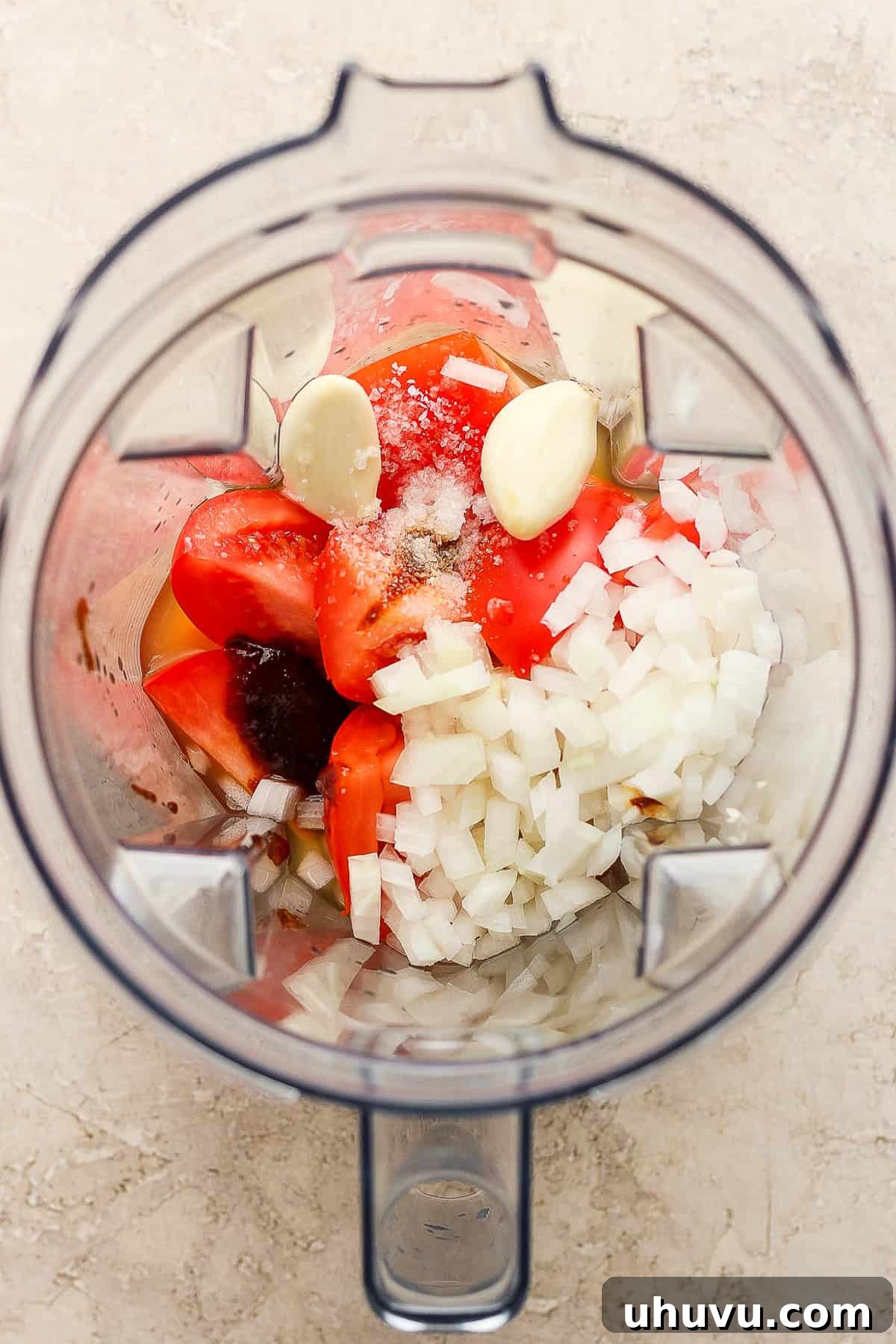 Little Shell Pasta Soup 4 Fresh ingredients for the tomato broth, including tomatoes, onion, garlic, and bouillon, ready to be blended for Sopa de Conchas.