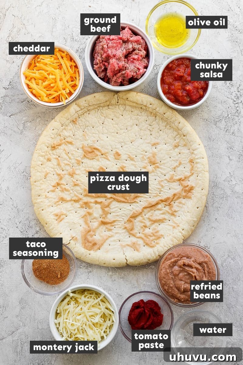 Zesty Mexican Pizza 3 Individual ingredients for Taco Pizza laid out on a wooden board: pizza dough, olive oil, ground beef, taco seasoning, tomato paste, water, refried beans, chunky red salsa, shredded Monterey Jack cheese, shredded mild cheddar cheese, and a variety of fresh toppings.