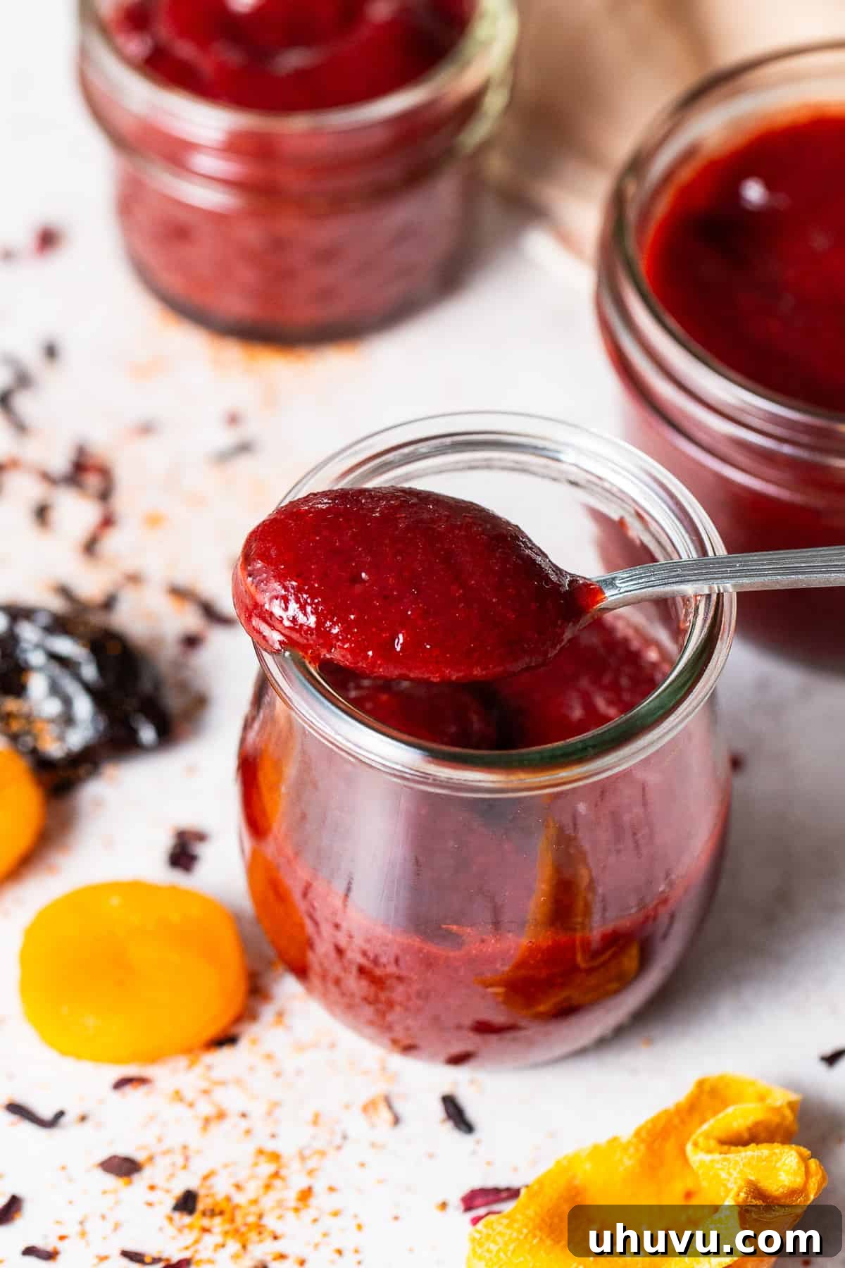 Homemade Chamoy Perfection 2 Homemade chamoy on a spoon in a jar, showcasing its rich, enticing color and texture.