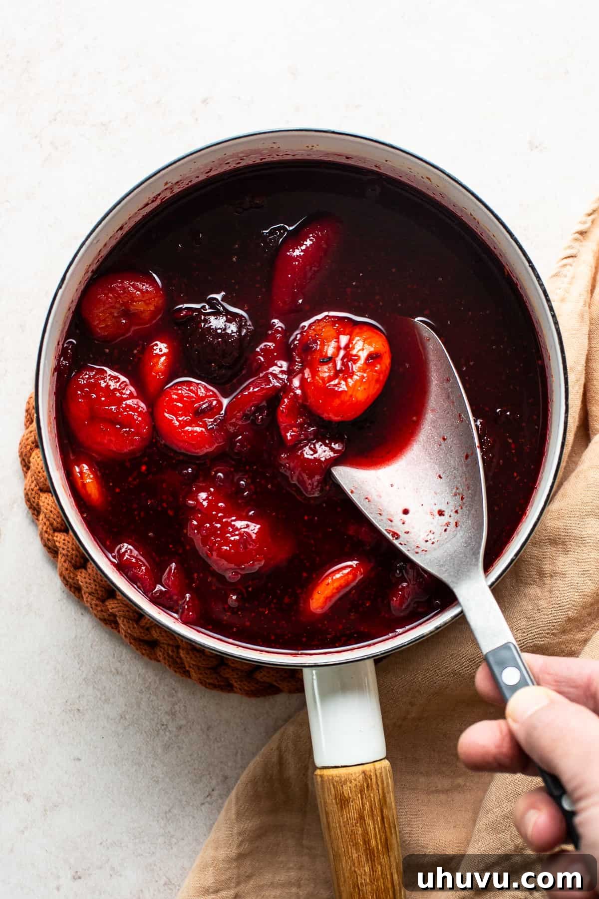 Homemade Chamoy Perfection 5 Reduced, cooked ingredients for chamoy sauce in a pot, cooling before the blending stage, showing softened fruits and deepened color.