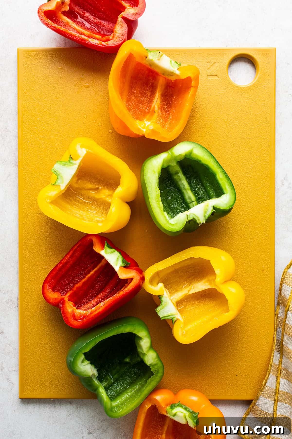 Fiesta Stuffed Peppers 5 Bell peppers meticulously cut in half with all seeds and veins removed, ready for stuffing.