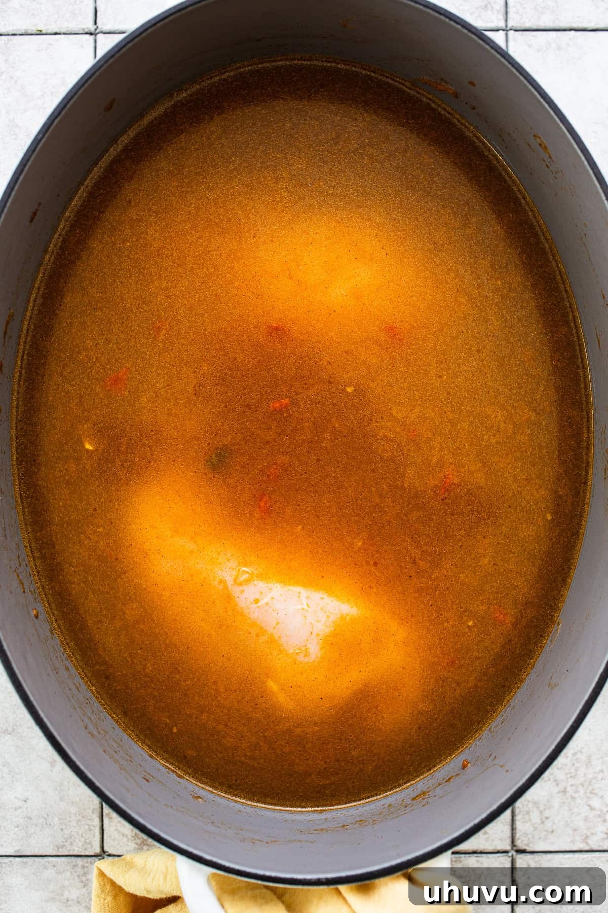 Authentic Yucatecan Lime Soup 6 Chicken broth and chicken in a pot of sopa de lima before being cooked.