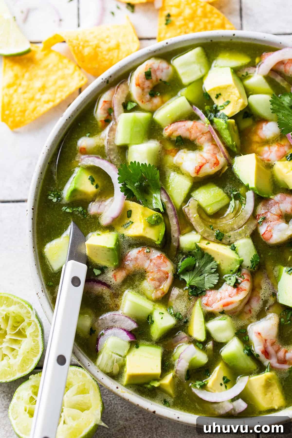 Chili Lime Shrimp 7 Aguachile in a bowl with avocado, cilantro, cucumber, and red onion.