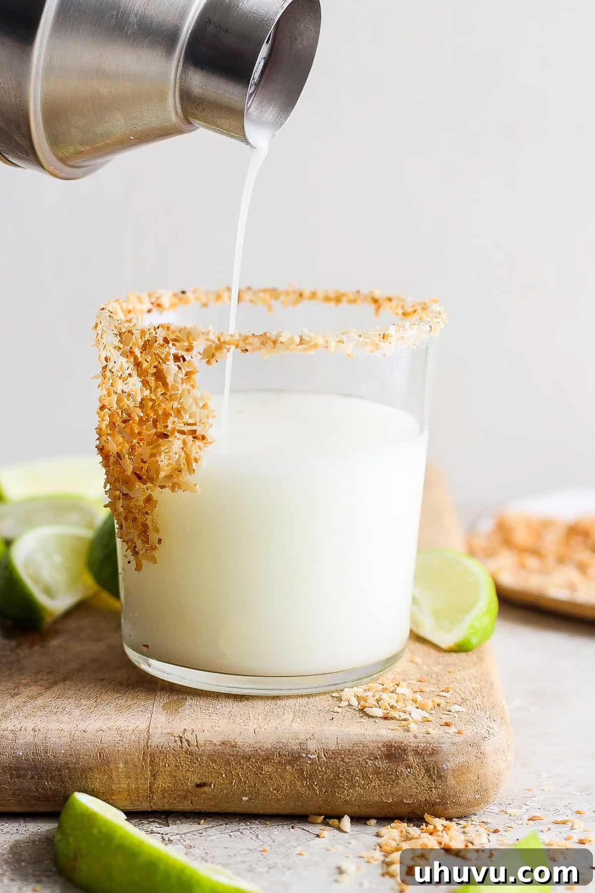 Tropical Coconut Margarita 7 Pouring the freshly mixed coconut margarita into a prepared glass