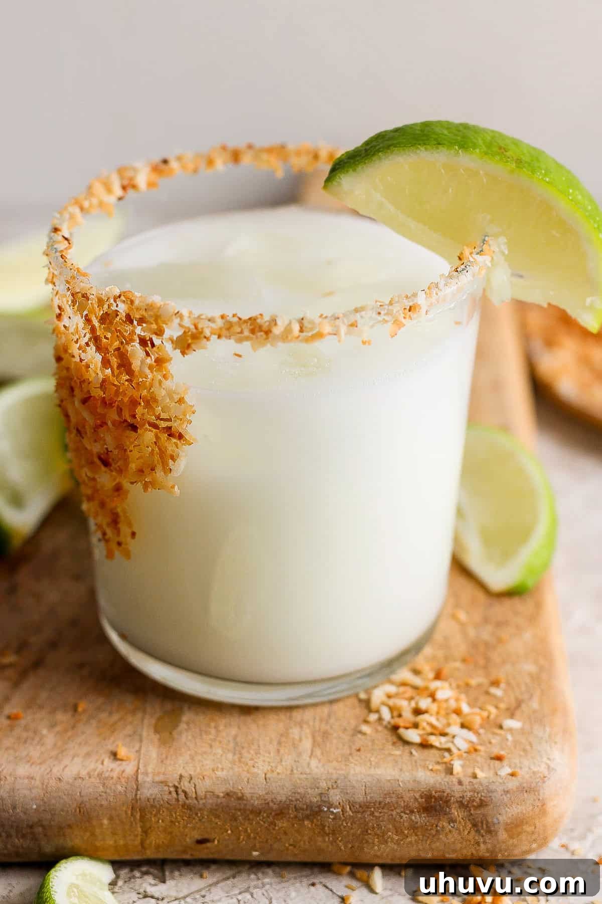 Tropical Coconut Margarita 8 Coconut margarita ready in a glass with a lime wedge
