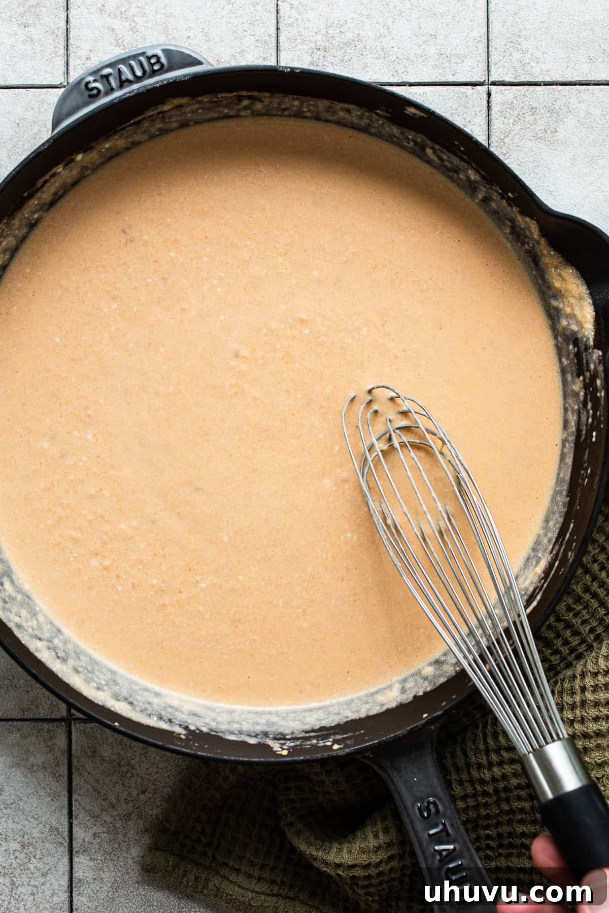 Crimson Spaghetti 6 Whisking the cream cheese and Mexican crema into the tomato sauce until smooth.