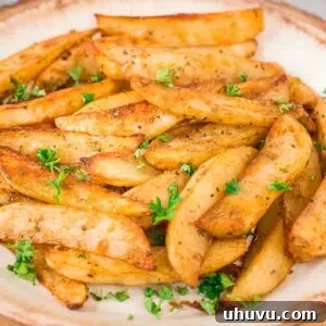 Close up of baked potato wedges on a plate, ideal for recipe card