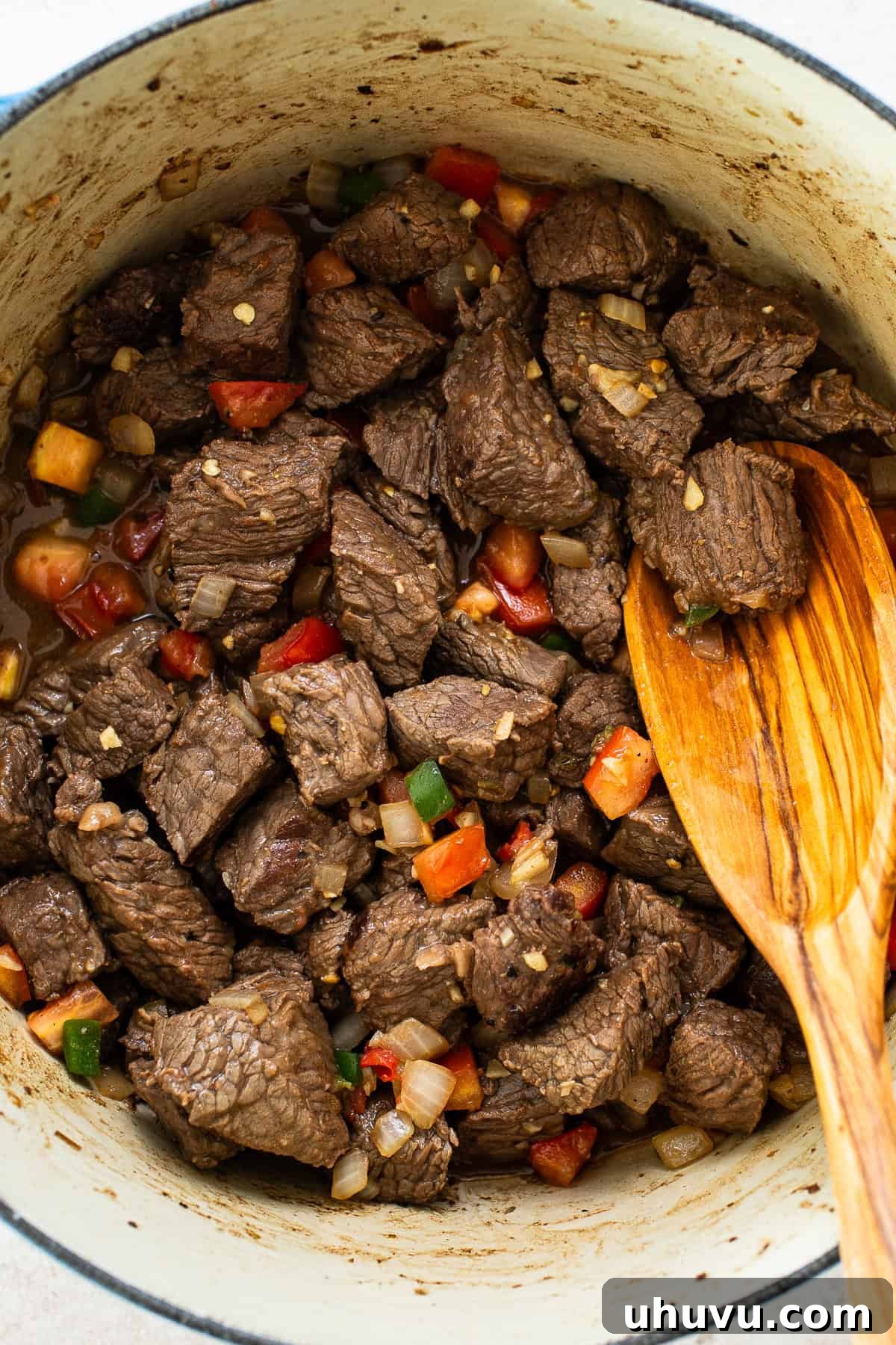 Slow-Simmered Beef Perfection 5 Seared beef combined with diced yellow onion, jalapeño, minced garlic, and soy sauce, simmering in a Dutch oven, building the aromatic base of the stew.