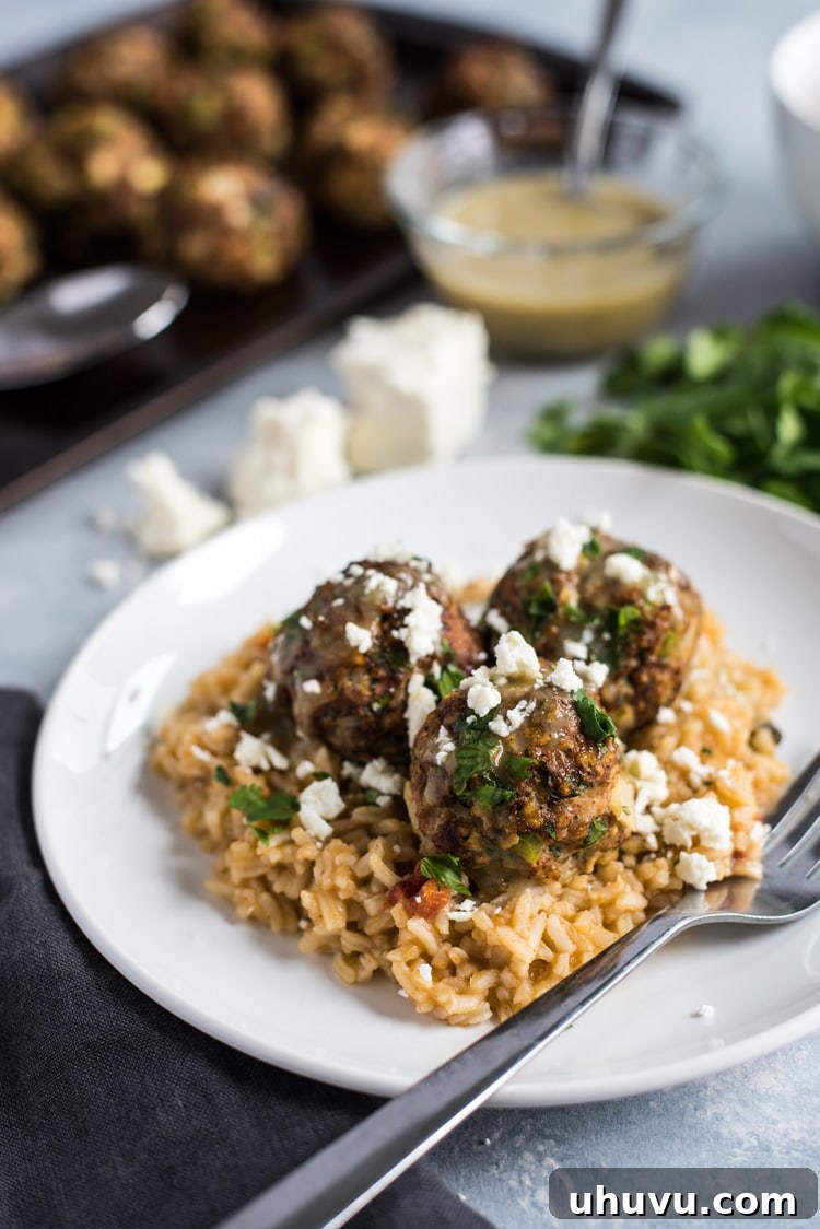 These Mexican Turkey Meatballs made with cilantro, garlic and a packet of taco seasoning are a great appetizer or weeknight meal when served with Arroz Verde (green chile rice).