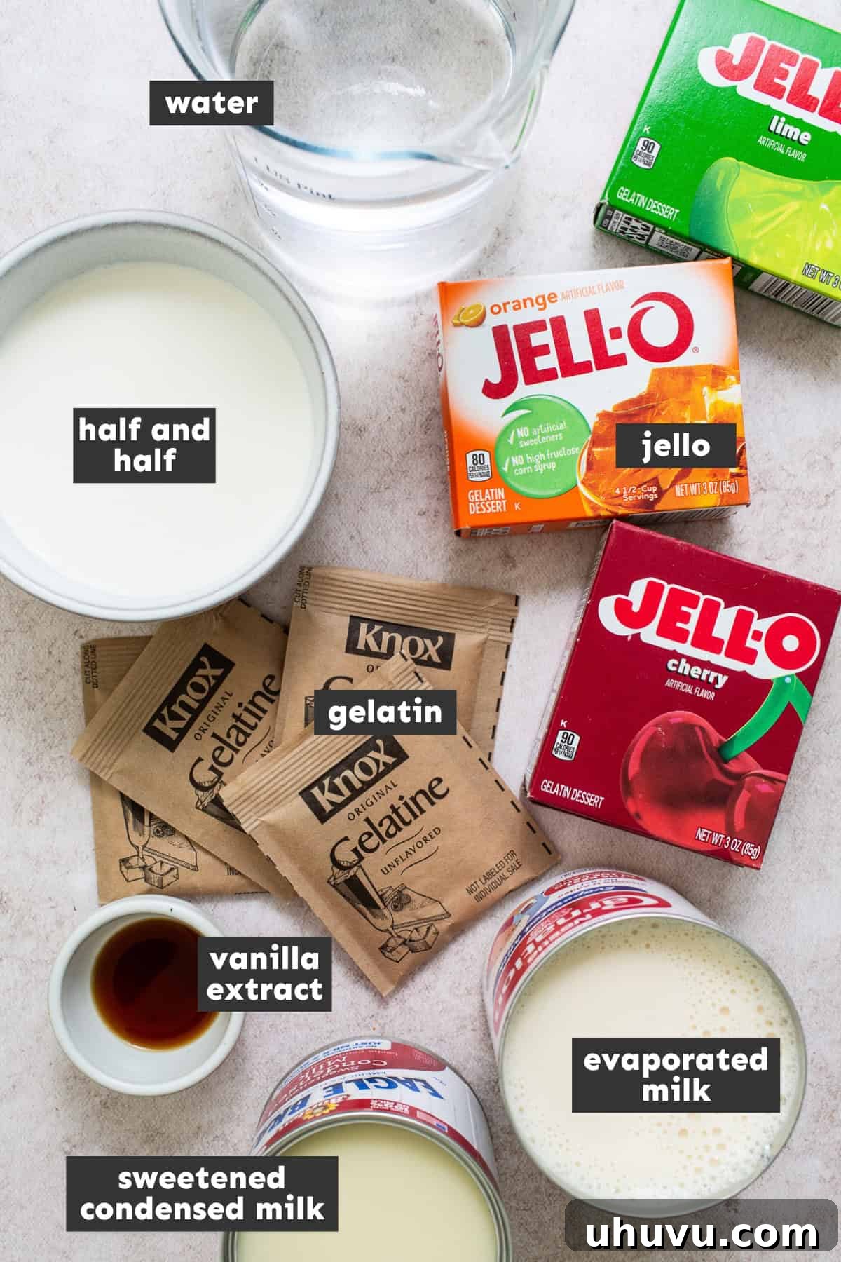 Mosaic Gelatin 3 Ingredients for Gelatina de Mosaico laid out on a table, including various milks and gelatin packets.