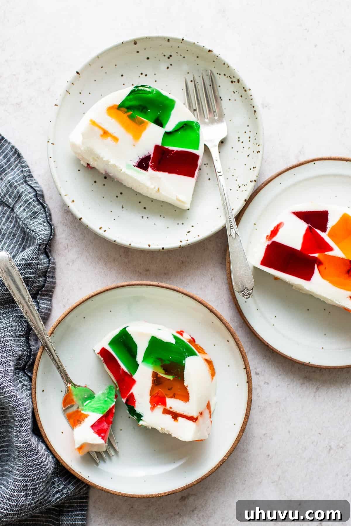 Mosaic Gelatin 9 Colorful slices of Gelatina de Mosaico elegantly arranged on a table, ready to be enjoyed as a refreshing dessert.
