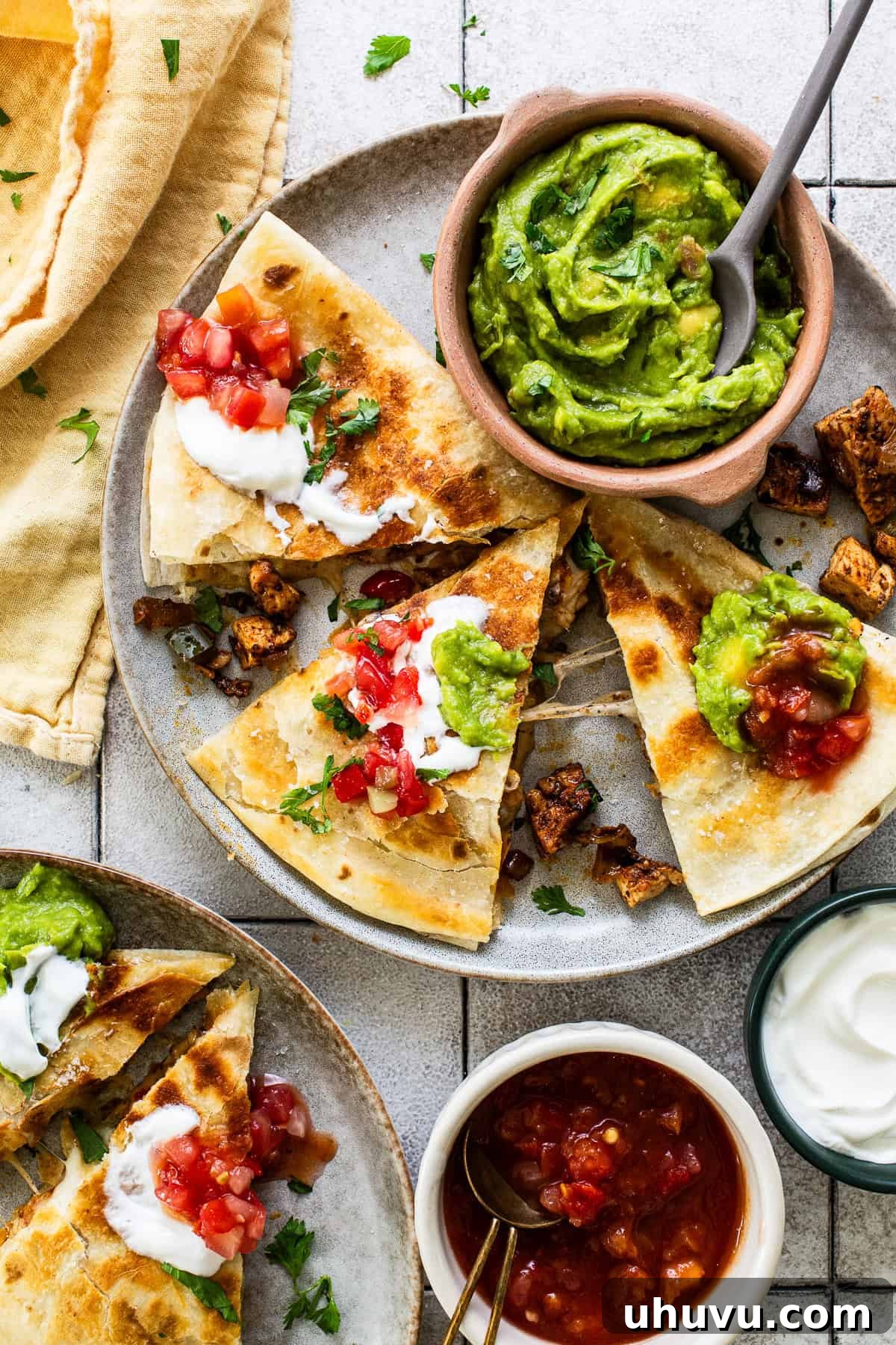 Zesty Chicken Fajita Quesadilla 7 Cooked chicken fajita quesadillas, neatly cut into triangles and arranged on a serving plate.