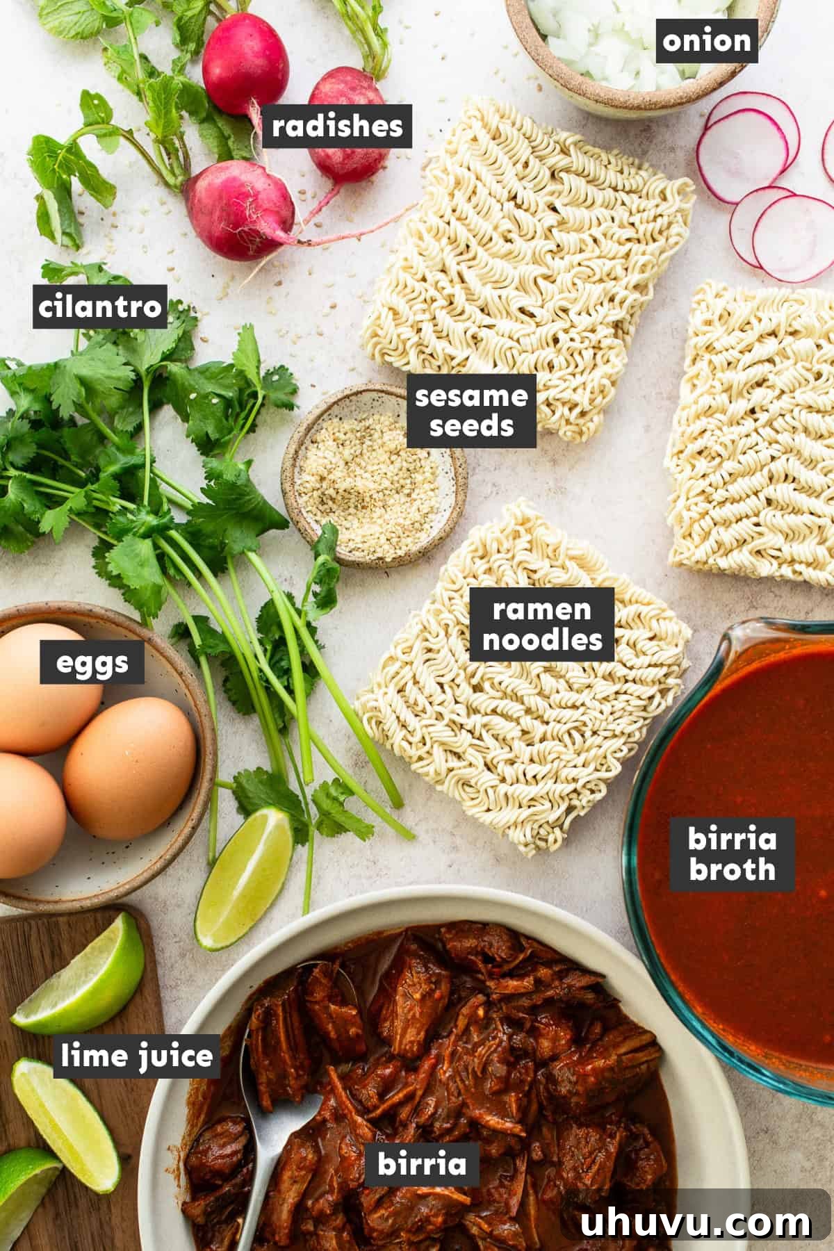 Ultimate Birria Ramen 3 All the fresh and flavorful ingredients for Birria Ramen, including fresh herbs, spices, and noodles, neatly arranged on a rustic wooden table, ready for preparation.