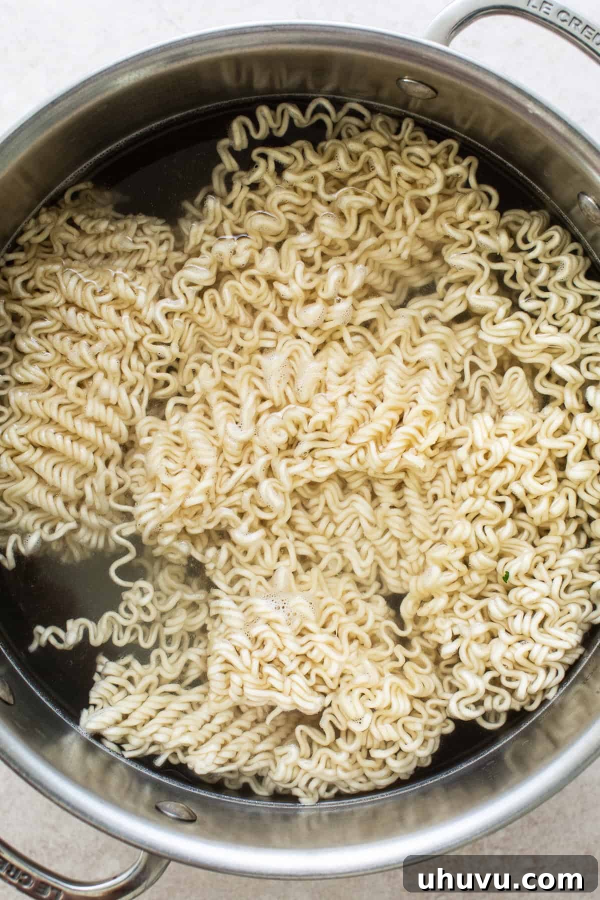 Ultimate Birria Ramen 4 A large pot filled with boiling water, perfectly cooking ramen noodles to achieve their ideal texture before being combined with the rich birria broth.