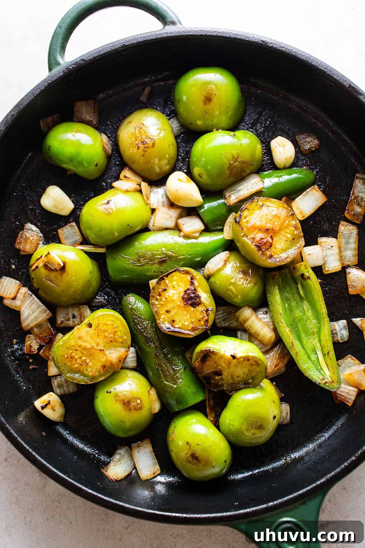 Aztec Tortilla Bake 4 Skillet with tomatillos, jalapeños, onions, and garlic being caramelized.