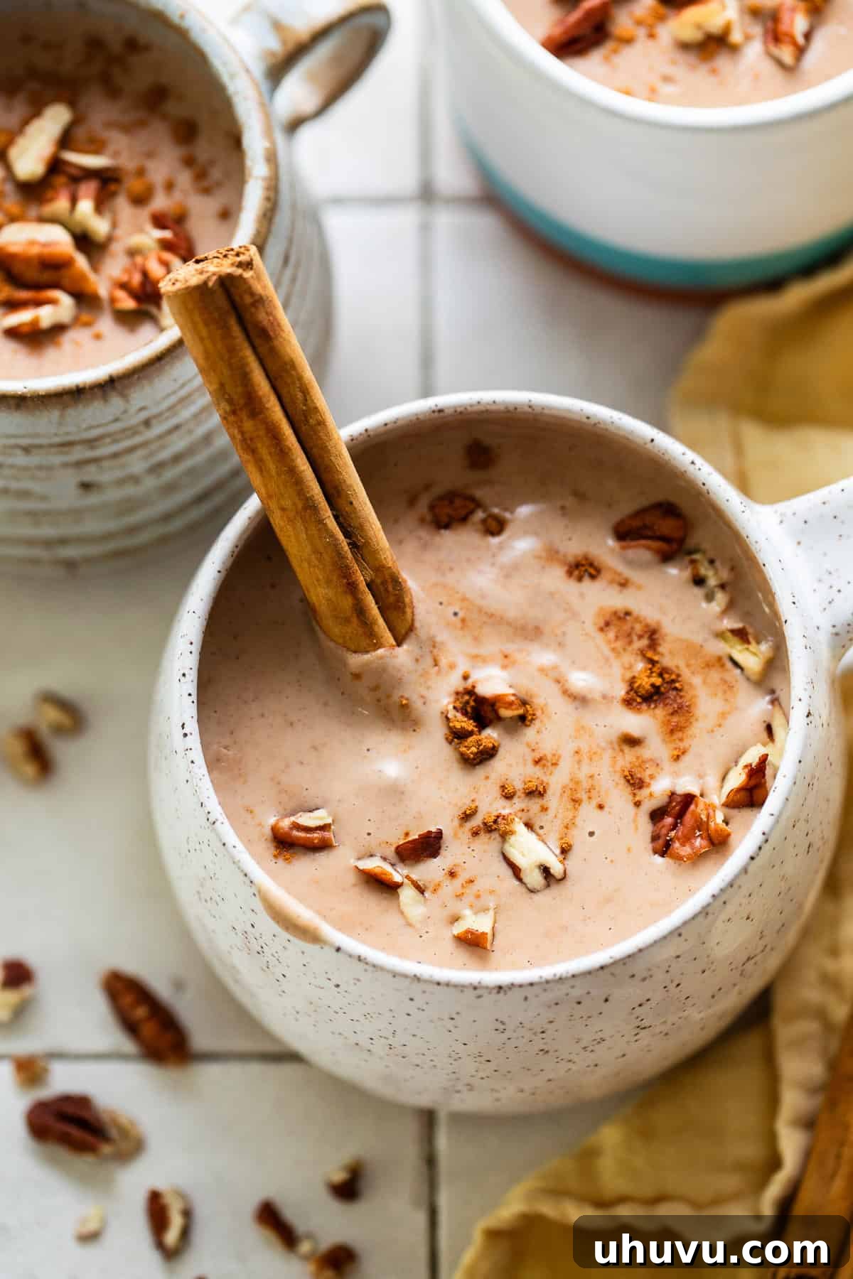Atole de nuez in a mug with a cinnamon stick.