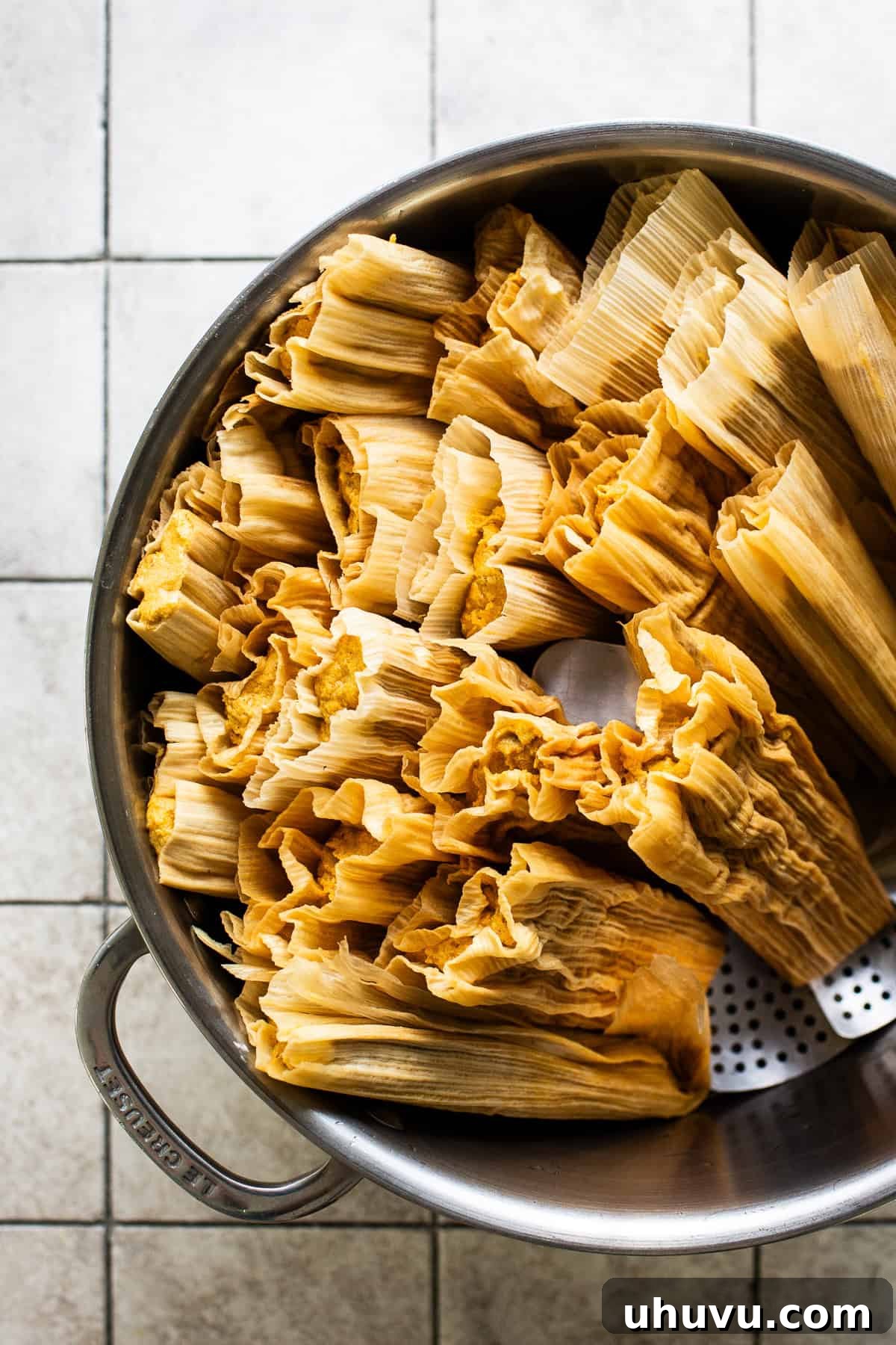 Harvest Pumpkin Tamales 6 Pumpkin tamales neatly arranged upright in a steamer pot, ready for the steaming process to cook them to perfection.
