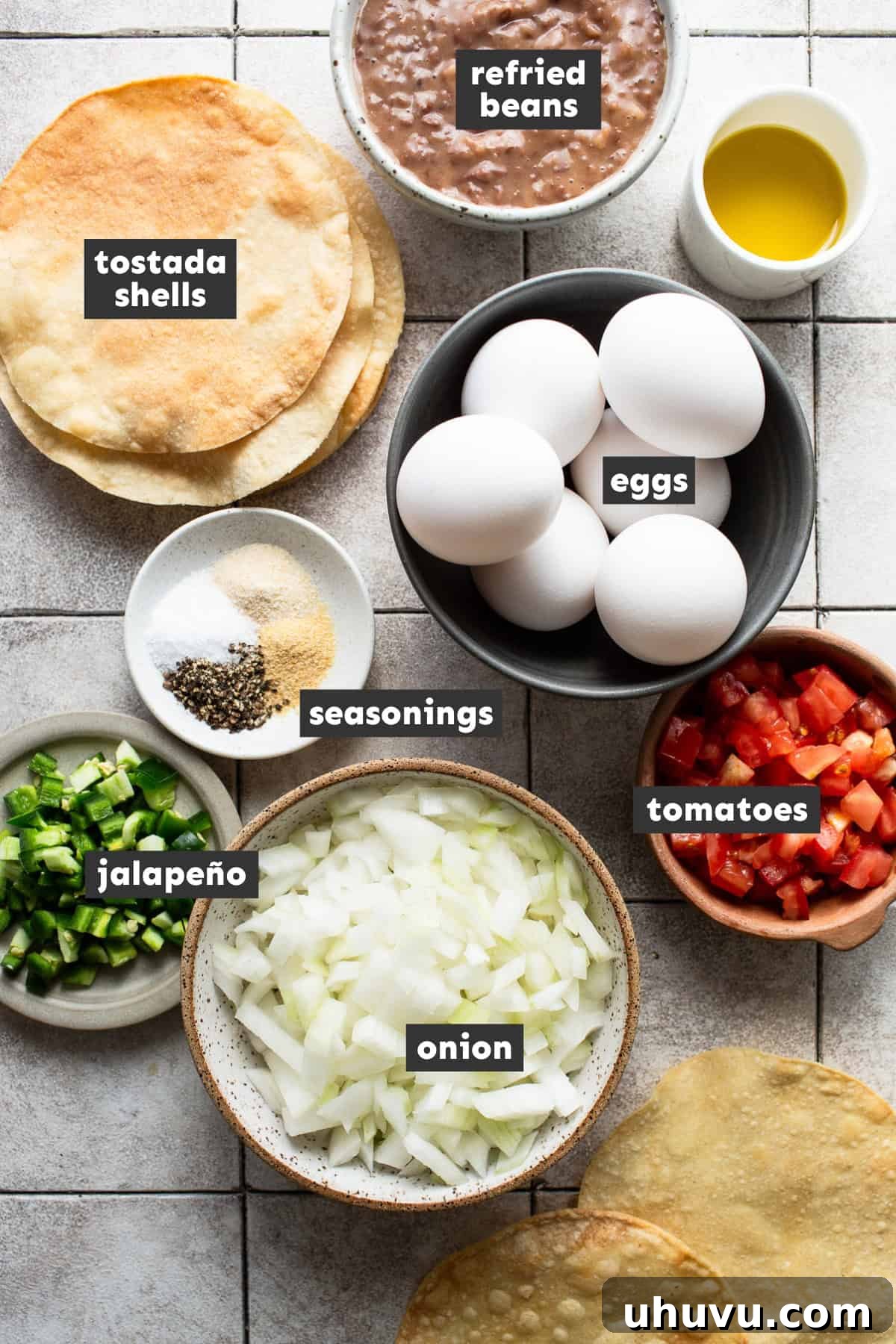 Sunrise Crunch Tostadas 3 All ingredients for breakfast tostadas laid out on a table, including eggs, vegetables, beans, and tostada shells.