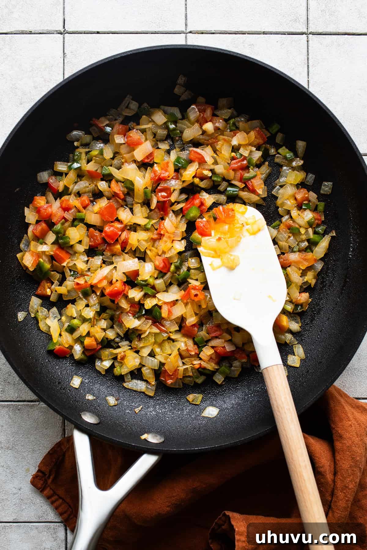 Sunrise Crunch Tostadas 5 Skillet with all vegetables and peppers in some olive oil being sauteed until tender and fragrant.