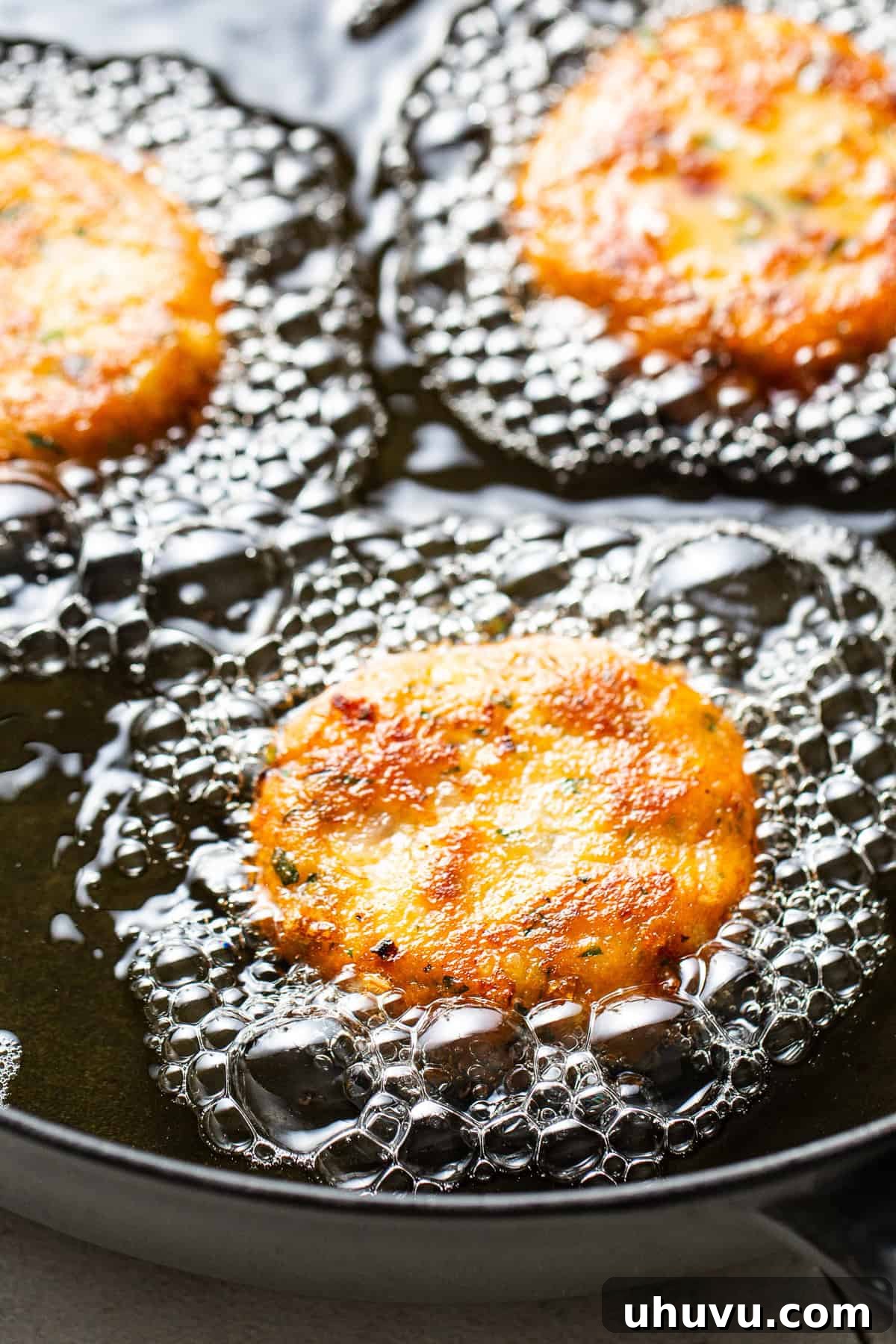 Potato Pancakes 6 In a shallow skillet the tortitas de papa are frying.