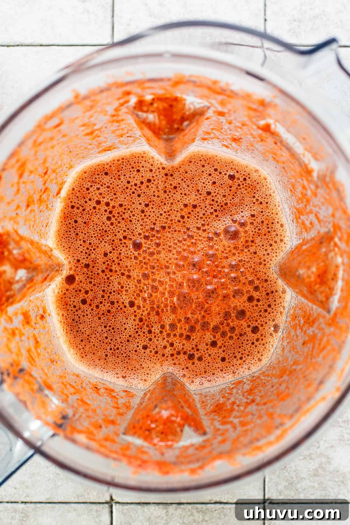Yucatan's Achiote Slow Roast Pork 4 A vibrant, reddish-orange marinade for cochinita pibil blended smoothly in a blender, ready to coat the pork.