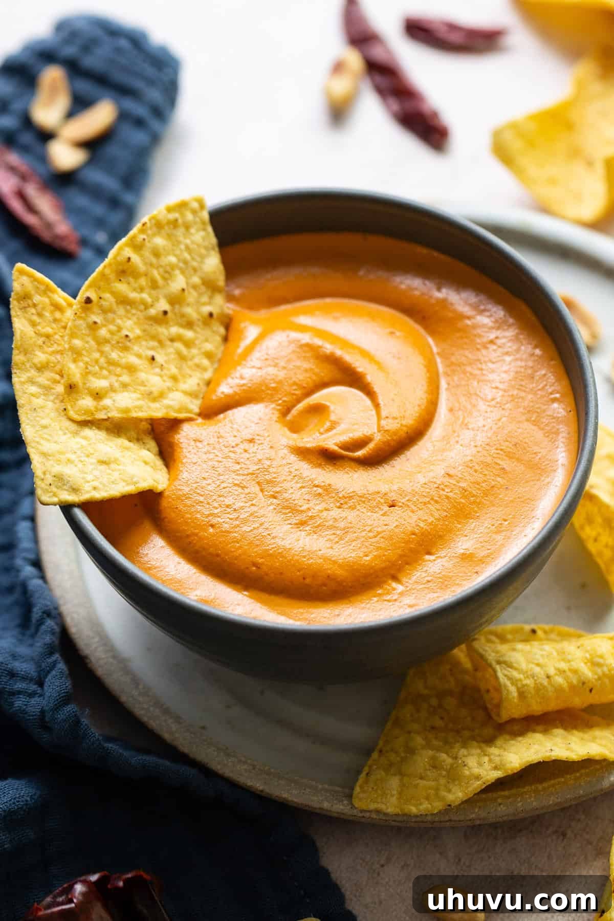 Creamy Peanut Salsa 7 A serving bowl filled with freshly blended Salsa de Cacahuate, accompanied by a side of crispy tortilla chips.