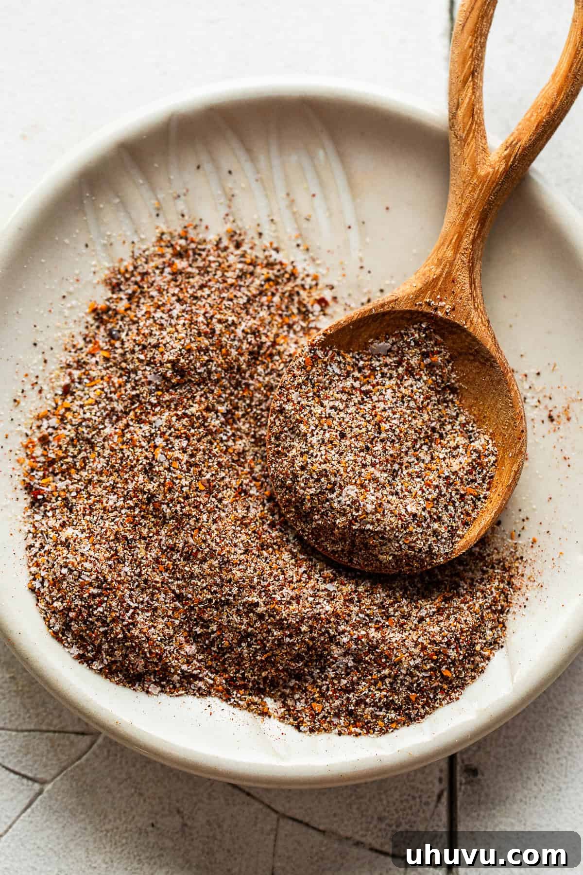 Sizzling Fajita Spice 6 Fajita seasoning recipe blend in a bowl with a measuring spoon.