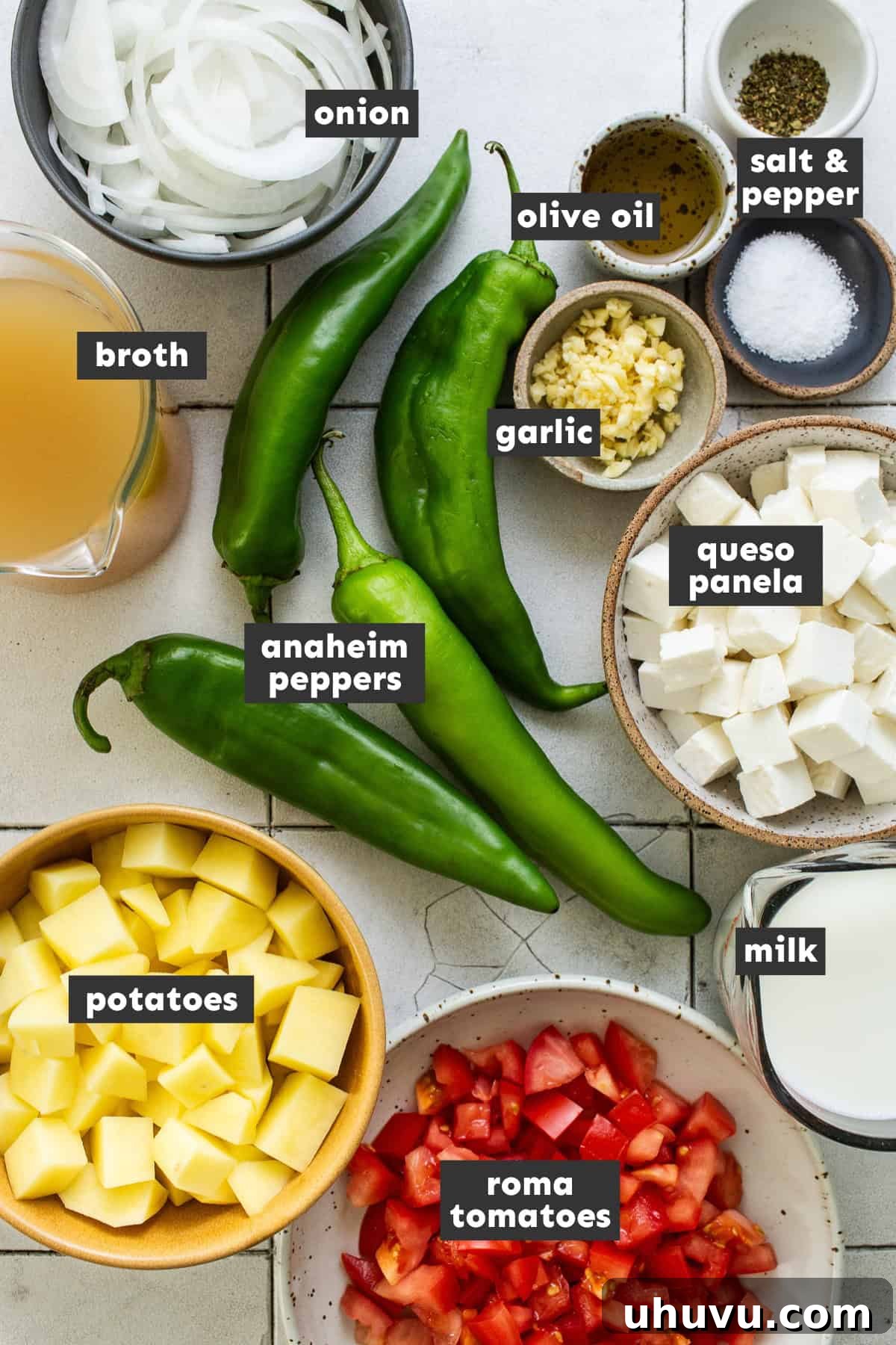 Creamy Cheese Soup 3 Assortment of fresh ingredients laid out for making Caldo de Queso, including peppers, tomatoes, onions, garlic, potatoes, and cheese.