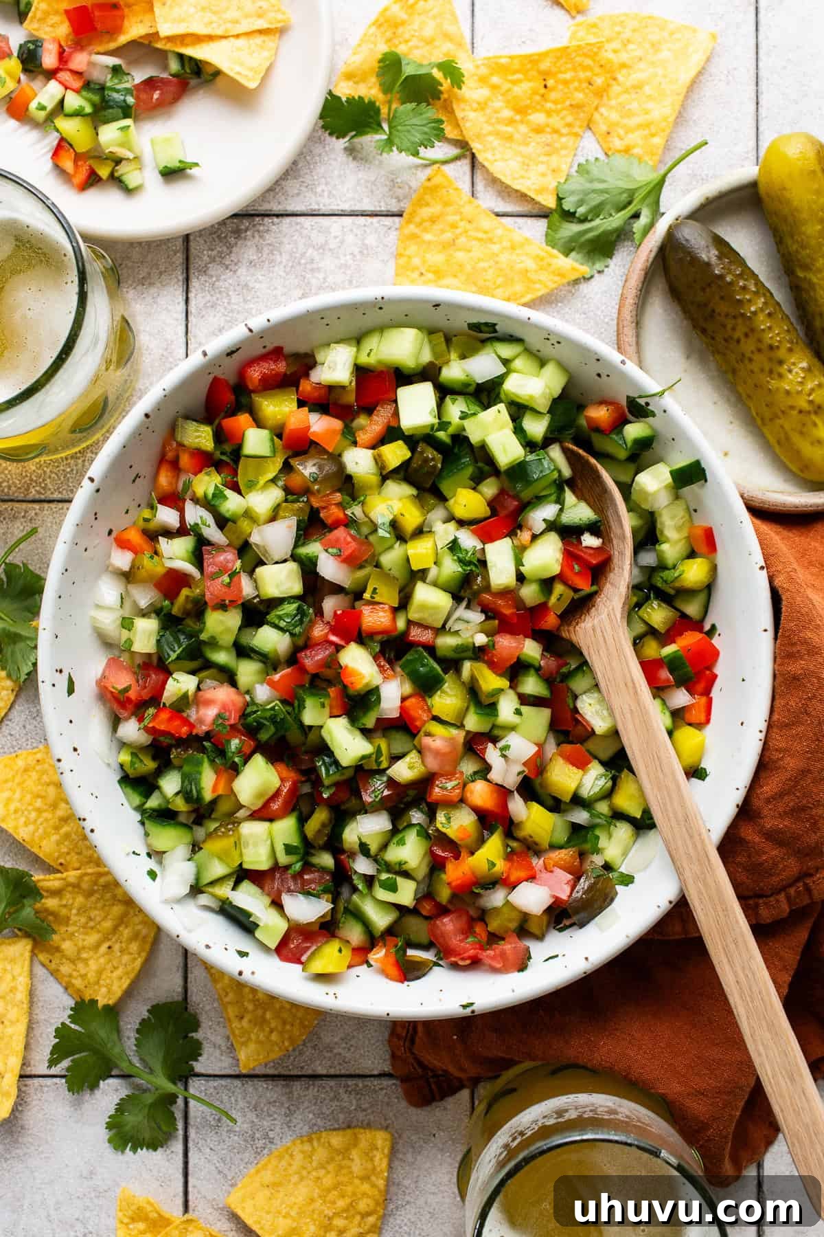 Briny Salsa 2 A vibrant bowl of Pickle de Gallo, brimming with diced pickles, tomatoes, and cucumbers, ready to be enjoyed as a refreshing snack or topping.