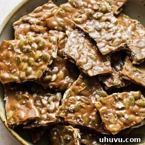 Pieces of pumpkin seed brittle in a bowl ready to serve.