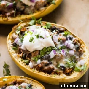 Stuffed spaghetti squash filled with chicken, beans, peppers, and onions.